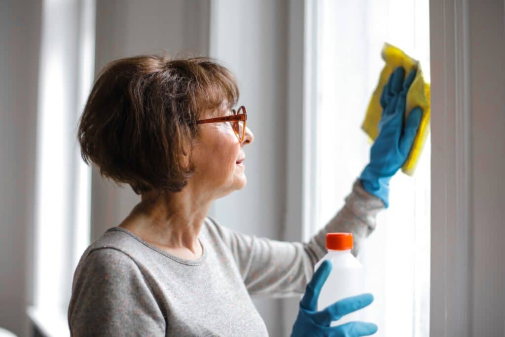 Elderly Person cleaning the windows, Reasons to build a legal suite in Calgary